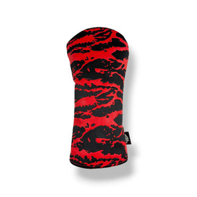A golf club headcover with a bold red and black abstract tiger-stripe pattern, shown on a clean white background with a soft drop shadow.