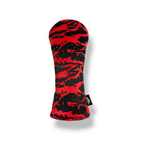 A red and black camouflage-patterned golf club headcover on a white background with a soft drop shadow.