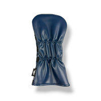 A navy blue leather golf club headcover with a gathered, pleated design and a small black brand tag on the side, shown against a plain white background.