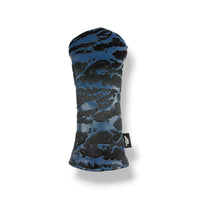 A golf club headcover with a blue and black cloud-like camouflage pattern, shown on a clean white background with a soft drop shadow.
