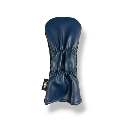 A navy blue leather golf club headcover with a stitched texture and a small black brand tag on the side, shown against a plain white background.