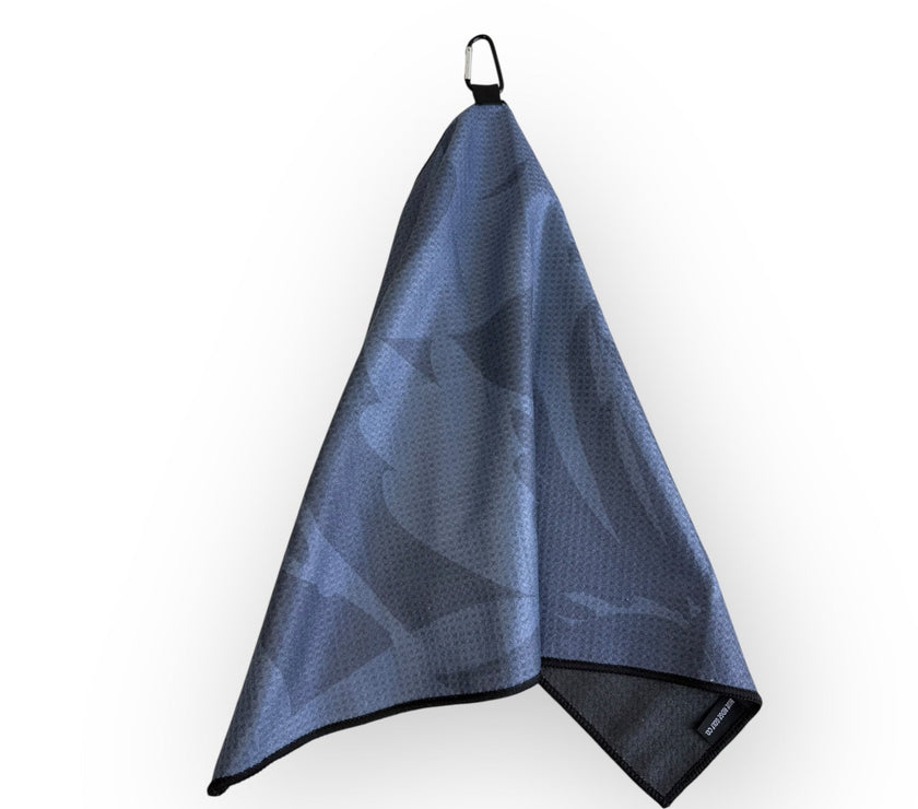 Grey golf towel with black border and carabiner clip on a white background